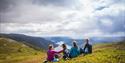 group of walkers and dog take a break and enjoy the view from Skorve