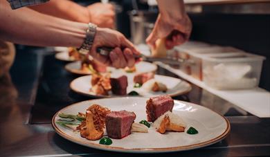 chefs at restaurant Jacob & Gabriel put food on the plate