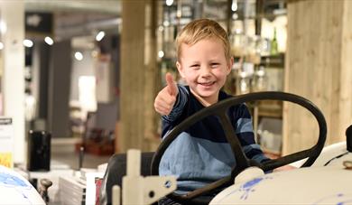 little boy sitting on a porcelain car at Porsgrund's Porcelain Factory 