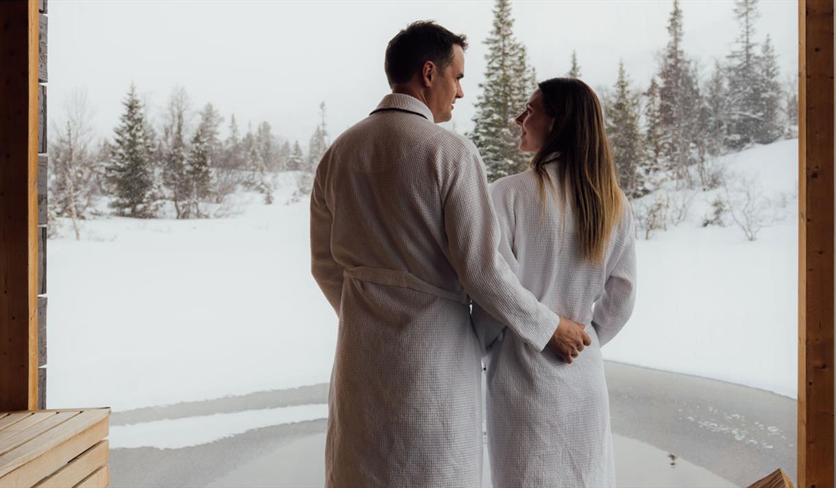 couple on a floating sauna in winter