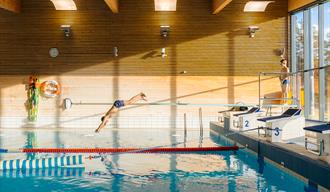 Boy dives into the pool.