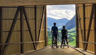 Couple on bicycles at the viewpoint in Flatdal.