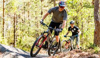 2 men cycle on the cycle path at Kragerø Resort