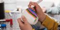 child paints on a cup at the Porcelain Museum in Porsgrunn