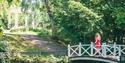 Brekkeparken with a bridge over the duck pond and a pavilion in the background