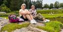 2 women are sitting on a rocky shore at Dikkon bathing area on Sandøya in Porsgrunn