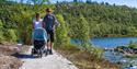 couple with pram walks on a walk at Vasseventyret