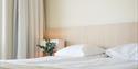 Bed in room at Kragerø Resort