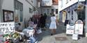 lady selling her gods on a narrow street in Brevik