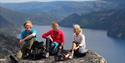 group of 3 sitting on a peak