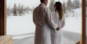 couple on a floating sauna in winter