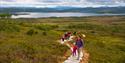 group of adults and children walking on the sherpastie
