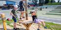 2 boys and a lady get ready for climbing in the Skien leisure park