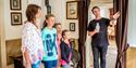 family on a tour of the Henrik Ibsen museum