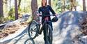 girl stands with a bicycle on the cycle path at Kragerø Resort