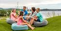 family sitting on seat cushions on the patio of Quality Hotel Skjærgården