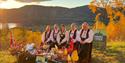 group of women in bunads with groceries from  the grocery store Joker
