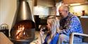 couple enjoying wine in front of the fireplace