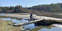cyclist rides over a bridge