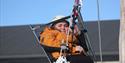 girl rides in an adapted zipline in the climbing park of Skien leisure park