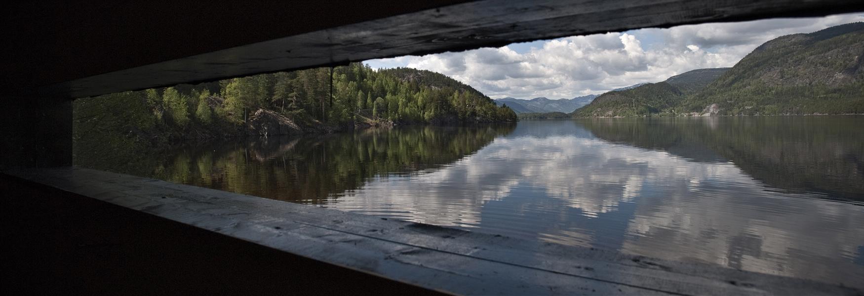 view of a lake through a narrow window in Seljord