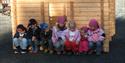 group of children in front of a half-timbered house at Vest-Telemark Museum Eidsborg