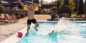 little boy jumps in swimming pool at Bø Hotel