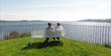 two ladies sitting on a bench by the battery in Brevik and looking at the sea