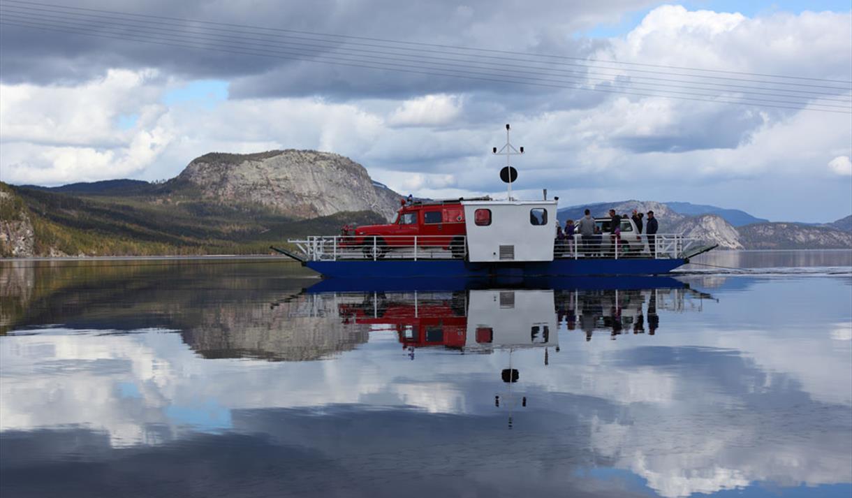 The Fjone ferry with 2 cars and several people on board operates over Lake Nisser in Telemark