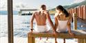 couple sitting on a bench at Dugg sauna in Notodden