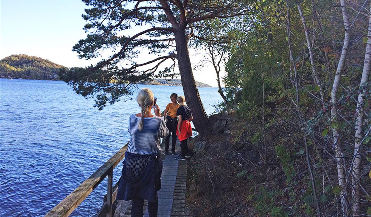 Lady takes picture of 2 boys on a trip on the coastal path from Brevik to Skjelsvik