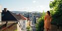 lady stands on top of Ibsentrappa in Skien and looks over the city