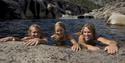 girl and two boys bathe in the potholes in Nissedal